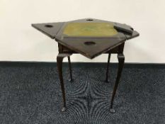 A walnut card table and three framed vinyl records