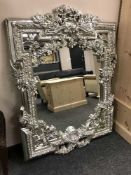 A highly ornate silvered mirror
