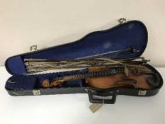 A late 19th/early 20th century violin in carry case with five bows