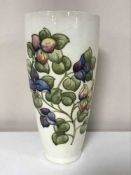 A tall Moorcroft flower vase on cream ground