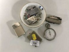 A silver sovereign case, three table lighters,