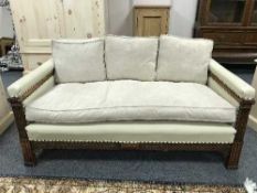 An Edwardian three-piece carved oak studded cream leather lounge suite