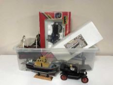A box of various model cars, model boats, motor bike,