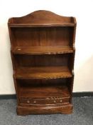 A set of mahogany open shelves retailed by Chapmans