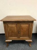 A light oak double door low cabinet