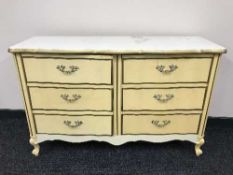 A cream and gilt six-drawer chest and a gilt framed mirror