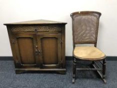 A oak corner unit and cane back chair