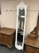 An ornate white easel mirror