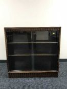 A mahogany sliding door bookcase