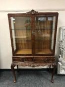 A reproduction mahogany display cabinet