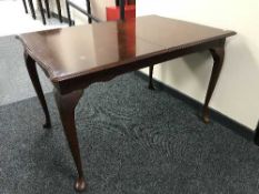 A mahogany dining table on pad feet