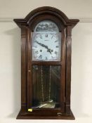 A modern mahogany cased weight driven wall clock