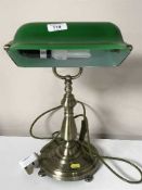 A banker's desk lamp, with green glass shade.