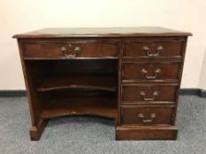 A good quality reproduction mahogany desk with green leather top,