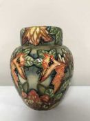A Moorcroft ginger jar decorated with tube lined flowers (lid damaged)