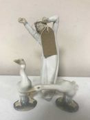 A Lladro figure of a boy in nightdress,