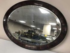 An early 20th century mahogany framed oval mirror