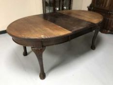 A mahogany extending table on claw and ball feet