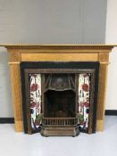 A tiled fire in set and a pine fire surround