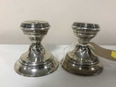 A pair of dwarf silver candlesticks