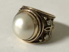 An impressive mabe pearl and diamond ring,