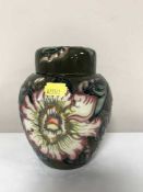 A Moorcroft ginger jar decorated with tube lined flowers