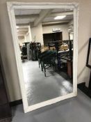 A contemporary cream framed over mantel mirror