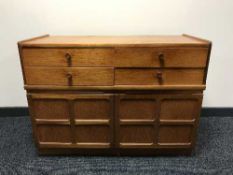 A teak chest of four drawers