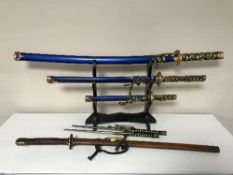 A display stand of three Samurai style swords,