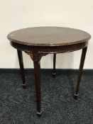 A circular antique mahogany occasional table