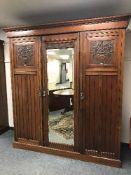 A late Victorian mahogany triple door mirrored wardrobe