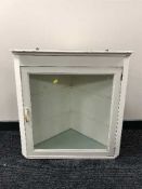 A painted corner cabinet