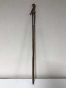 A carved figural walking cane