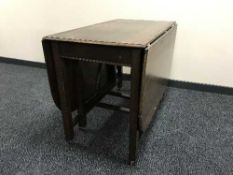 An oak drop leaf table and a commode armchair