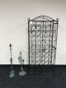 A wire wine rack and three candelabrum