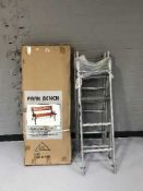 An aluminium extension ladder and a boxed garden bench