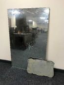 A large rectangular un-framed mirror and one other