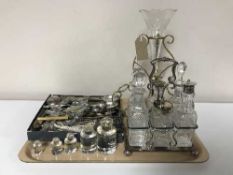 A tray of silver plated six bottle cruet, epergne with two glass shades,