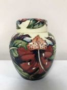 A Moorcroft ginger jar decorated with tube lined flowers