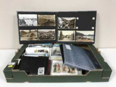 A box of assorted post cards and two post card albums