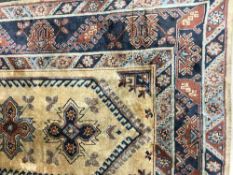 A fringed Persian carpet on golden ground