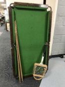 A 4' table topped snooker table together with four cues and tennis racket