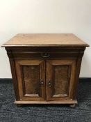 A mahogany double door cabinet with walnut panelled doors