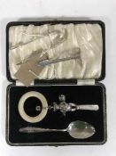 A silver baby spoon with rattle in case,