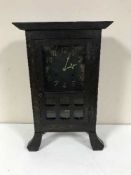 An early twentieth century oak mantel clock in the style of Liberty & Co