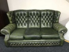 A green buttoned leather three seater Chesterfield wing backed settee (for restoration)