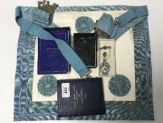 A freemason's apron together with a United Lodge 1926 book,