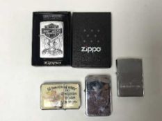 A Zippo Harley Davison lighter together with another Zippo and two other lighters (4)