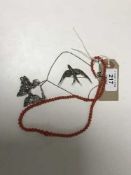 A silver marcasite necklace, together with a similar brooch and an antique coral necklace.