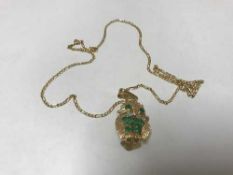 18 ct owl pendant set with emerald and chain. 12.